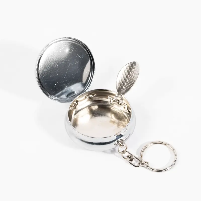 Compact custom pocket ashtray with airtight spring-loaded lid and laser-engraved branding, perfect for VIP corporate gifts