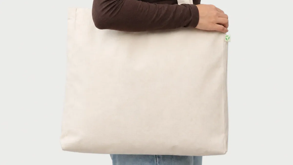 Natural cotton tote bag carried over the shoulder