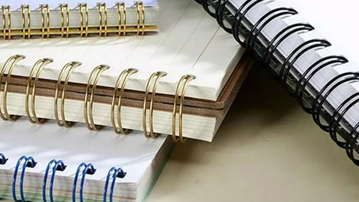 Double wire spiral notebook folded back to lie flat on a desk